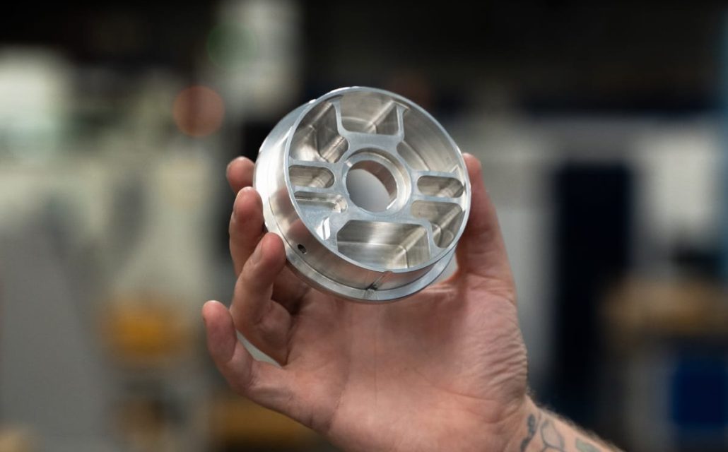 CNC machined aluminium component with radial milled pockets